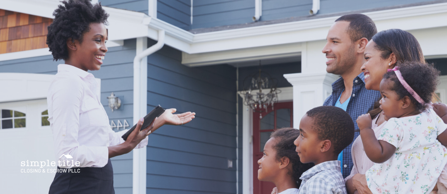 Real estate agent showing a family a house, closer in